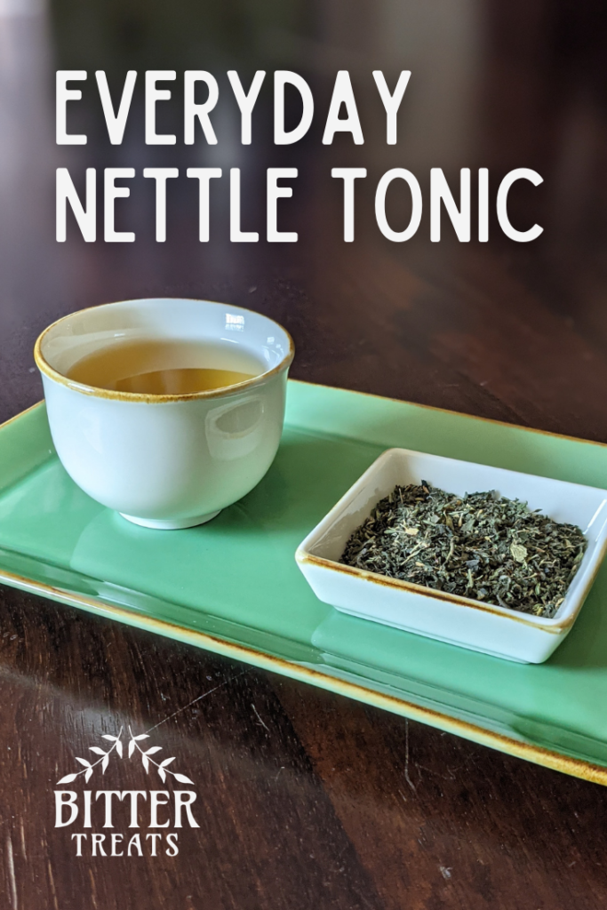 Photo of a cup of nettle tea next to a small dish filled with the dry herbal blend. Text reads: everyday nettle tonic.