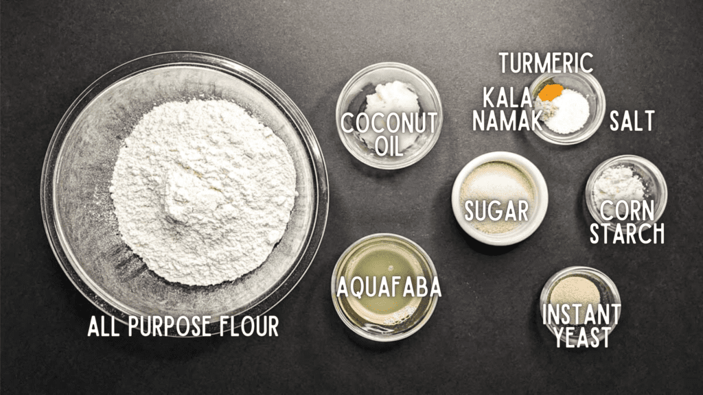photo of vegan challah ingredients with labels: all purpose flour, aquafaba, coconut oil, sugar, salt, corn starch, yeast, turmeric, salt, kala namak