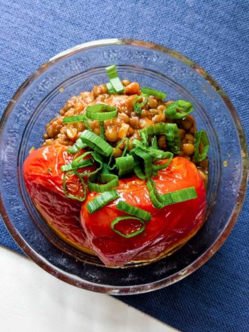 Photo of roasted tomatoes and lentils in a glass bowl