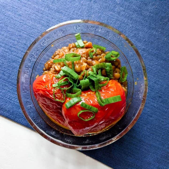 Photo of roasted tomatoes and lentils in a glass bowl