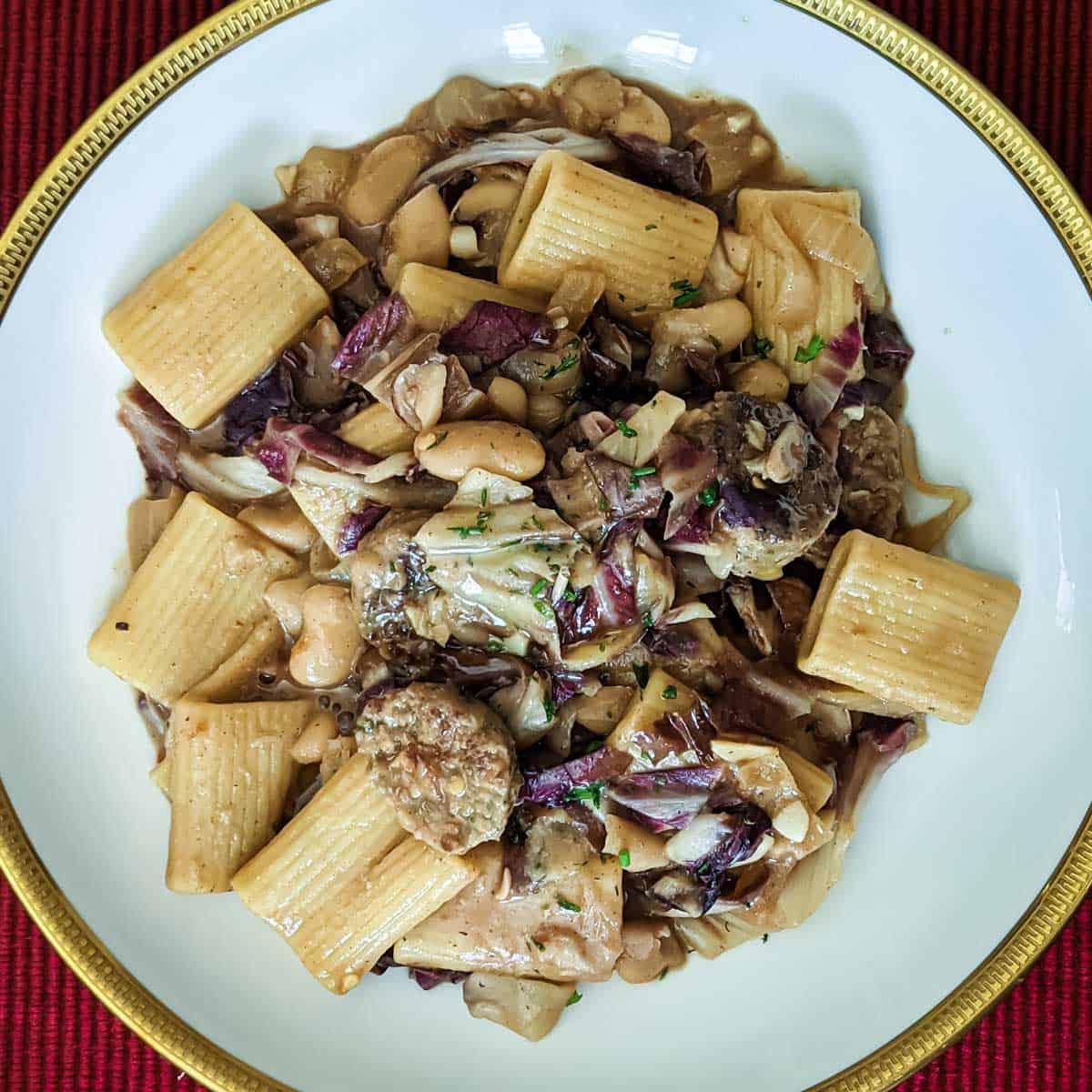 Overhead photo of a bowl of pasta with vegan sausage, radicchio, and white bean pasta