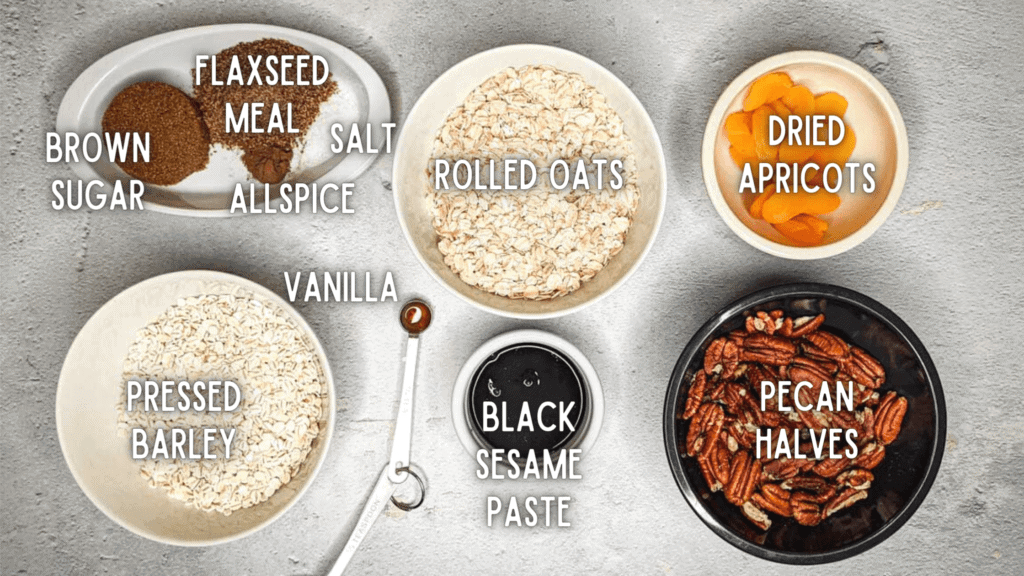photo of ingredients for black sesame granola: oats, barley, black sesame paste, apricots, pecans, brown sugar, allspice, salt, vanilla