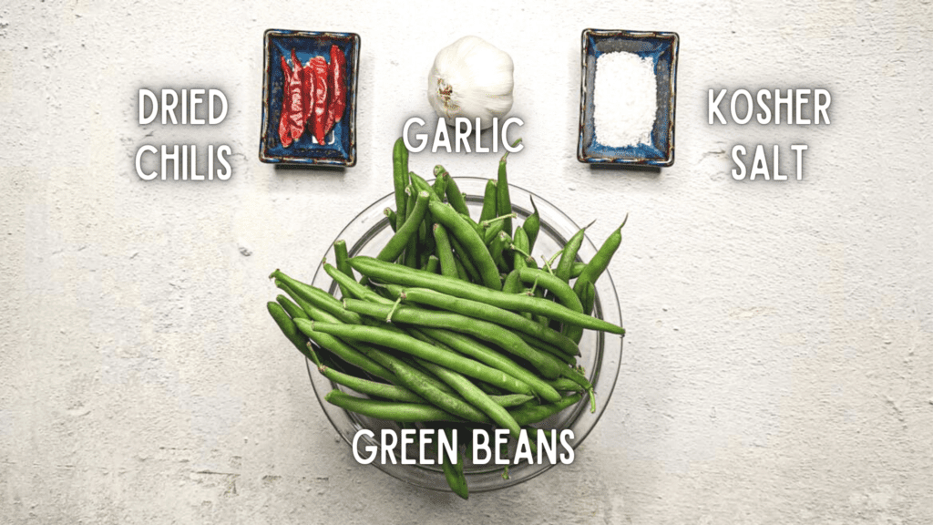 Photo of ingredients for lacto-fermented green beans: dried chilis, garlic, kosher salt, and green beans