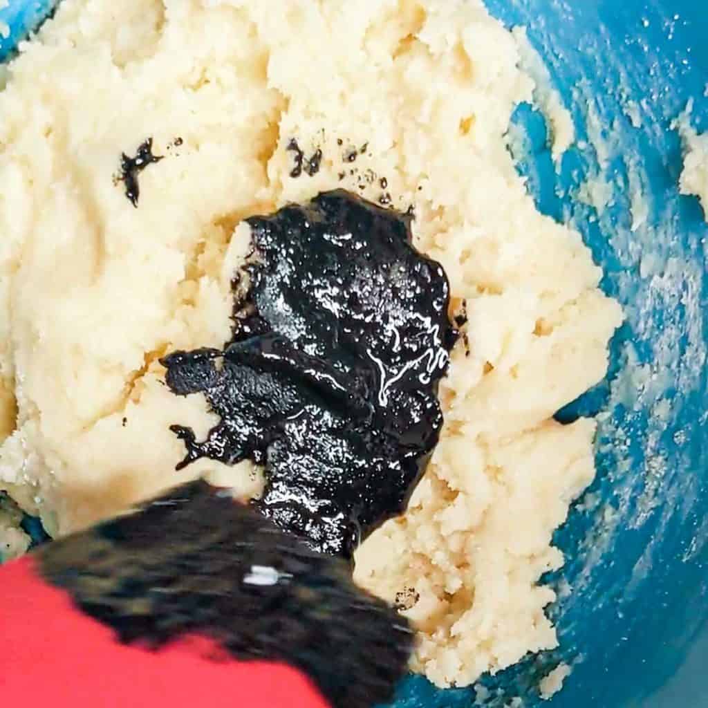 photo of marzipan dough with black sesame paste being added to it
