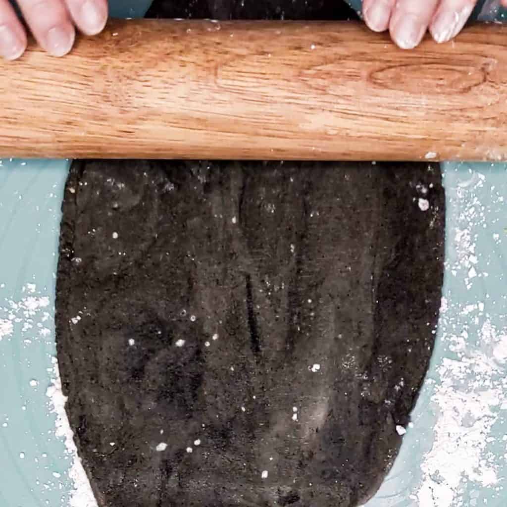Photo of black sesame marzipan being rolled out with a rolling pin