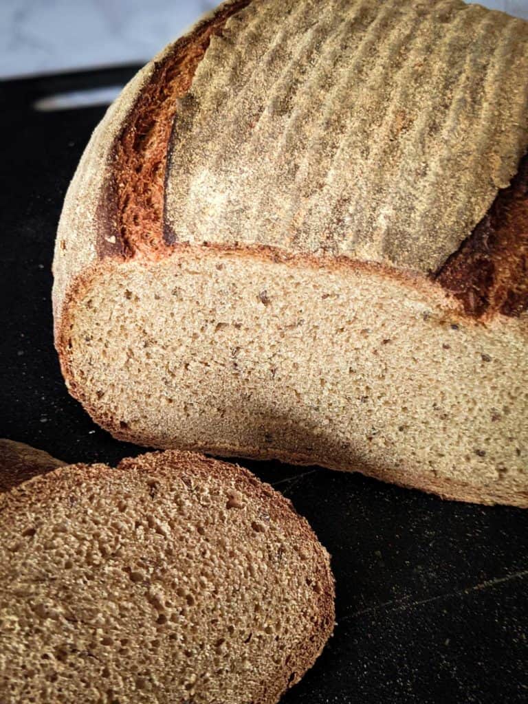 Side view photo of a sliced loaf of caraway rye bread