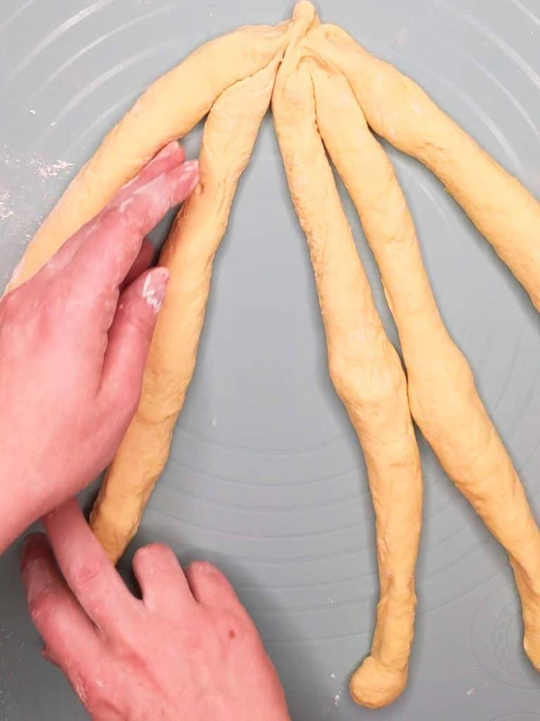 photo of challah separated into strands to be braided