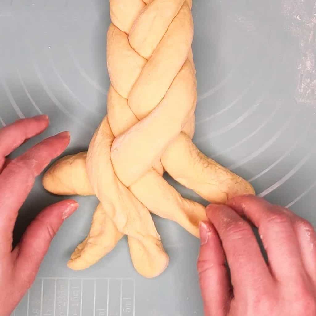 photo of challah loaf being braided