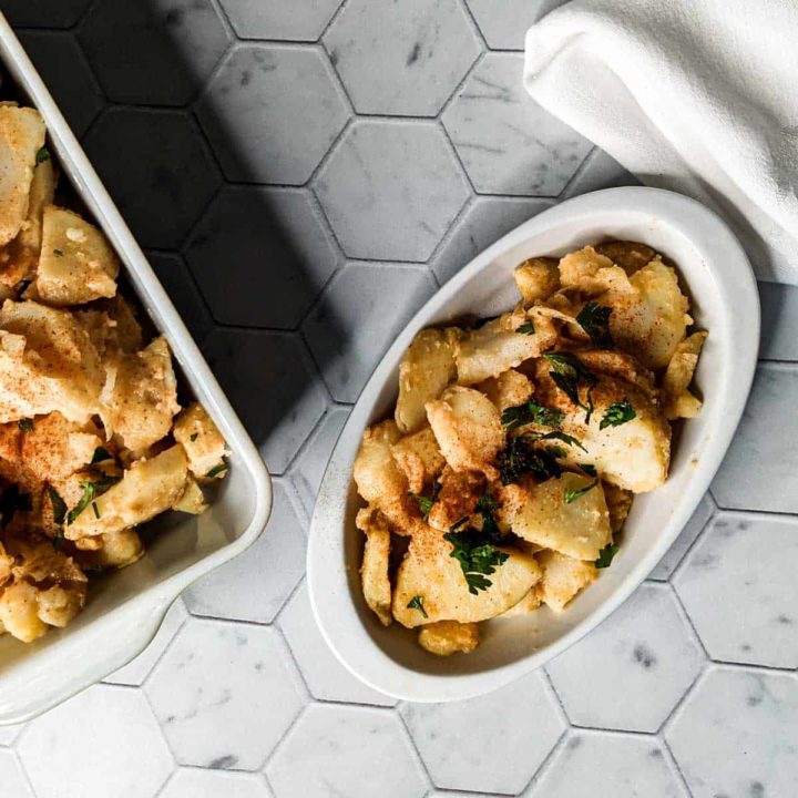 Overhead photo of a serving dish and an individual portion of hot german potato salad