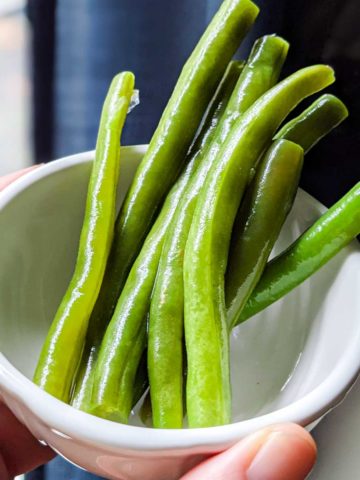 photo of lacto-fermented green beans in a small white bowl