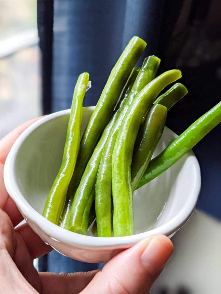 photo of lacto-fermented green beans in a small white bowl