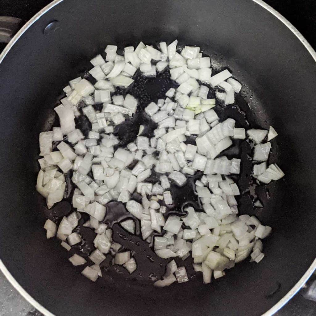 photo of onions being sauteed in a pot for split pea soup
