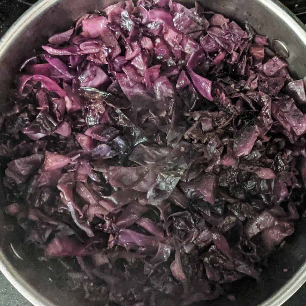 overhead photo of red cabbage in braising pan after cooking to tender