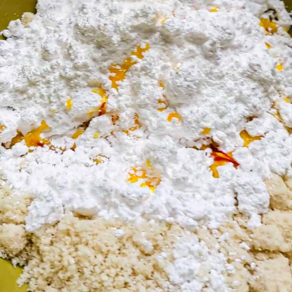 Photo of saffron liquid added to almond flour and powdered sugar